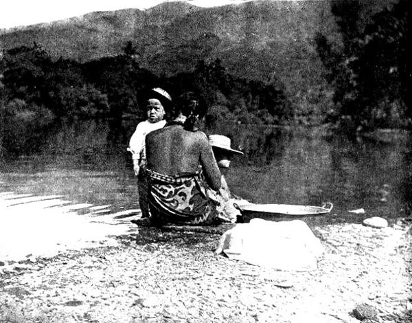 Native woman washing on the beach, Tahiti