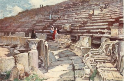 THE LOWER PART OF THE AUDITORIUM OF THE THEATRE OF
DIONYSOS AT ATHENS

Beginning at the left hand below, we notice first the breast-wall
dividing the orchestra from the auditorium, and below it again the
partially covered channel for rain-water. In the foremost row of marble
seats or thrones, the third seat to the right is that of the Priest of
Dionysos, distinguished by the exquisite relief, on the arm of the
throne, of Eros engaged in cock-fighting. Higher up in the auditorium
are pedestals for honorary statues.